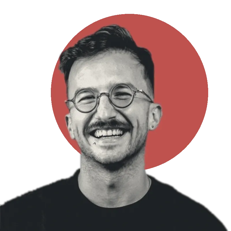 Branko, founder of Bushido, smiling, in black and white against a red sun.