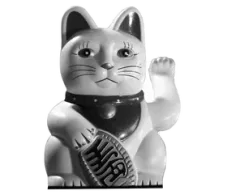 A black-and-white maneki-neko, the Japanese beckoning cat, raising one paw for luck.